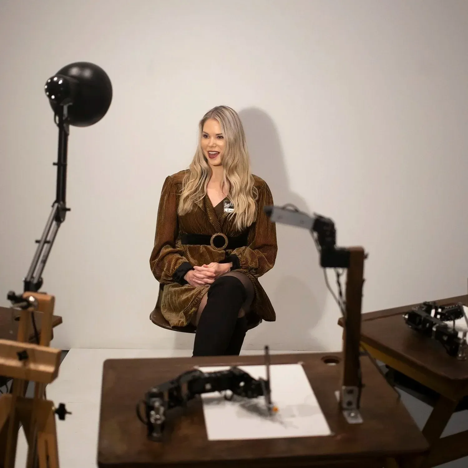 Human Study — robot artists sketching a seated visitor