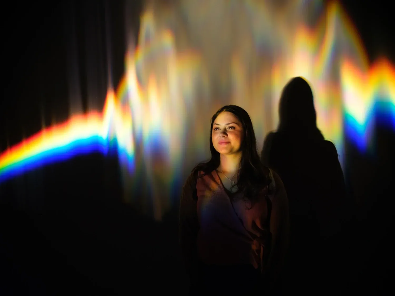 Visitors silhouetted inside Into the Light by Julia Carrillo