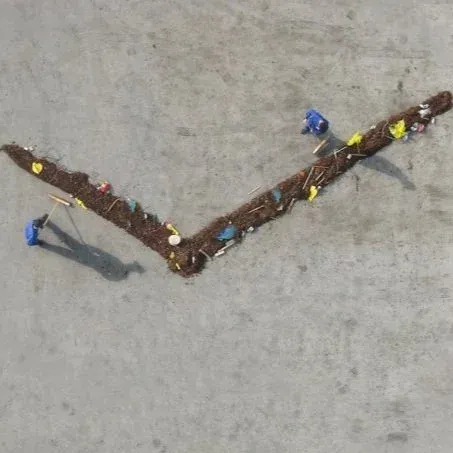Sweepers Clock — performers sweeping trash to indicate the time